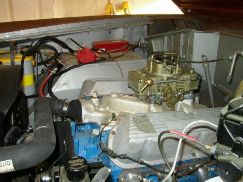 1995 Ford Bronco - Close-up view of the engine compartment, highlighting the carburetor and associated components.