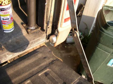1995 Ford Bronco - Close-up of the interior of a 1995 Ford Bronco tailgate, with a can of penetrating oil and a metal bracket visible.