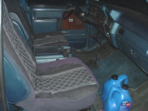 1982 Ford Bronco - Interior view of a truck, showing seats, dashboard, and floor with a blue jerry can.