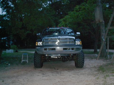 1997 Dodge 1500 - This 1997 Dodge Ram 1500 pickup truck is shown from the front, a prominent chrome grille and lifted suspension.