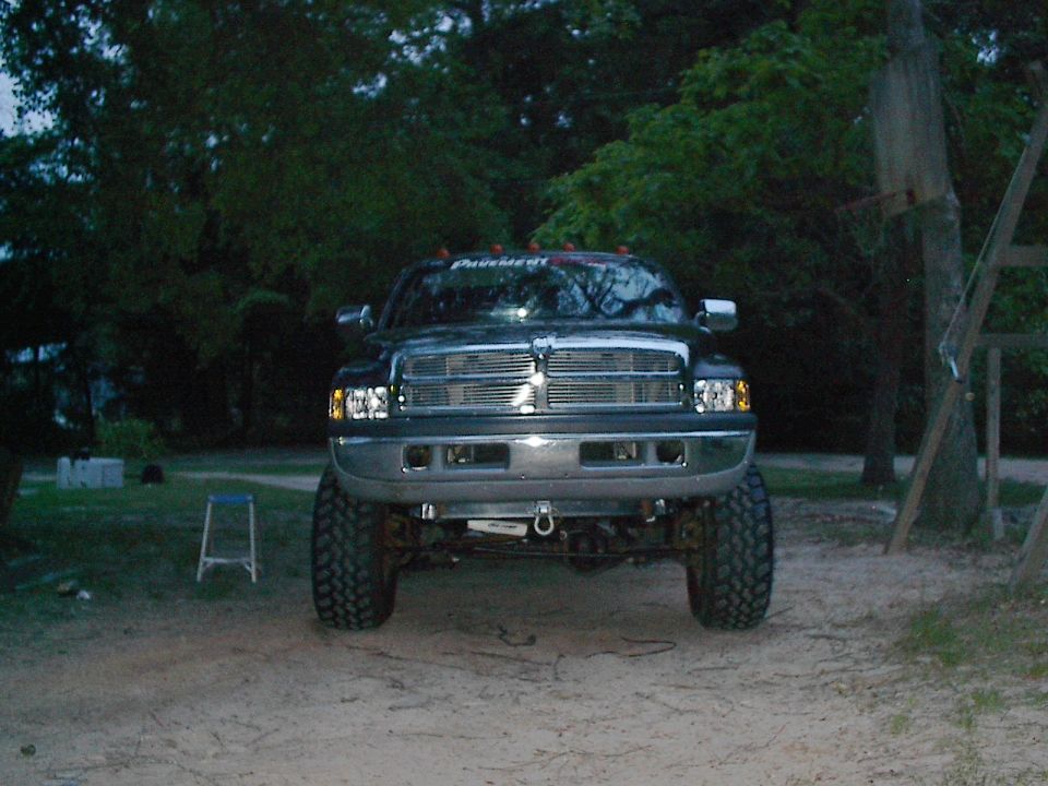 Front view of a lifted black 1997 Dodge Ram pickup truck with chrome grille