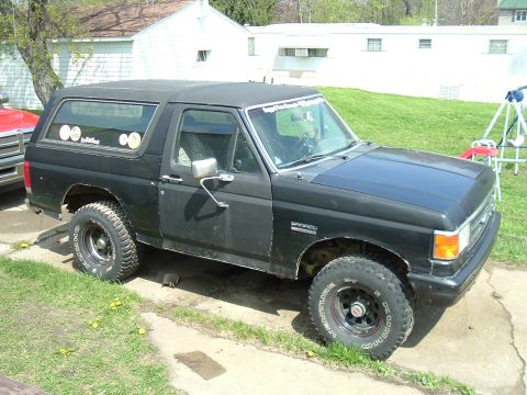 1989 Ford Bronco - This 1989 Ford Bronco is shown from a 3/4 front angle, aftermarket wheels and a black paint job.