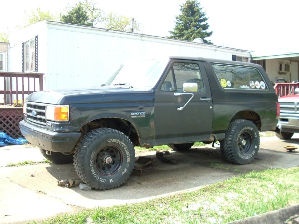 1989 Ford Bronco parked on a driveway, side view