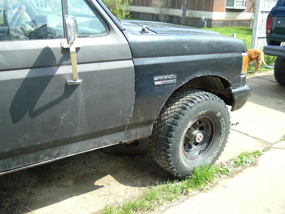 Black 1989 Ford Bronco front fender with 'BRONCO' badge and off-road tire