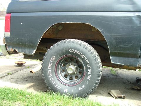 1989 Ford Bronco - Rear view of a 1989 Ford Bronco, highlighting the wheel well and tire.
