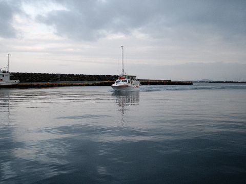 1996 Ford Bronco - Boats moving through a harbor with a breakwater in the background.