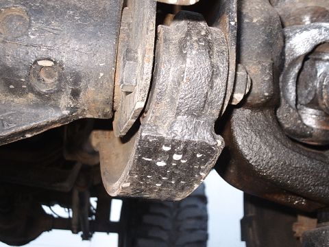 1996 Ford Bronco - Detail of a vehicle's suspension system, showing a cast metal component.