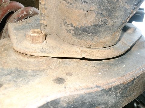 1996 Ford Bronco - Detail of a heavily rusted suspension component, likely from an older vehicle.
