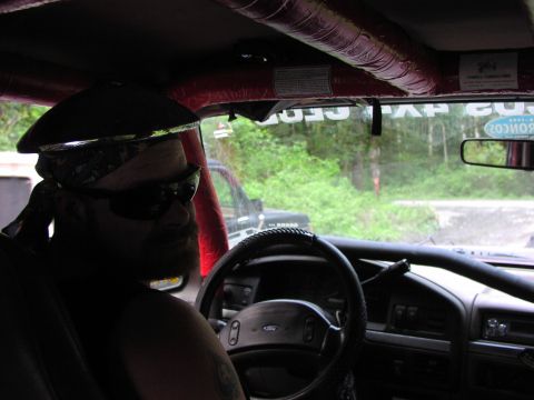 1993 Ford Bronco - Interior view of a 1993 Ford Bronco equipped with a roll cage, with another Bronco seen through the windshield.