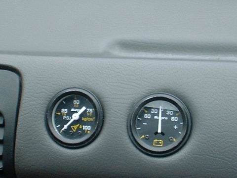 1991 Ford Escort - Close-up of two gauges on a vehicle's dashboard, showing tire pressure and battery status.