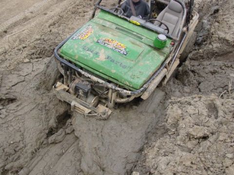 1992 Ford Bronco - This off-road vehicle is deeply stuck in mud, its front end submerged.
