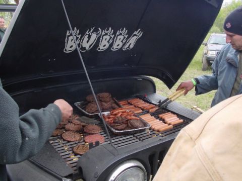 1992 Ford Bronco - Jeep hood converted into a grill for a cookout, with burgers and hot dogs cooking.
