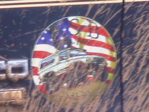 1991 Ford Bronco - A sticker a Bronco and the American flag is affixed to the side of a vehicle.