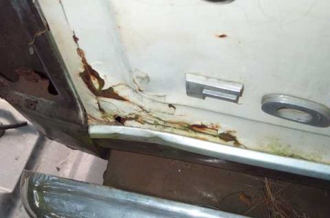 1979 Ford Bronco - Corroded door panel with trim details, showing significant rust damage.