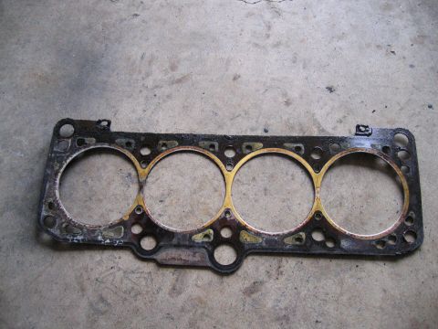 1987 Volkswagen Golf - This is a used engine head gasket, likely from a four-cylinder engine.