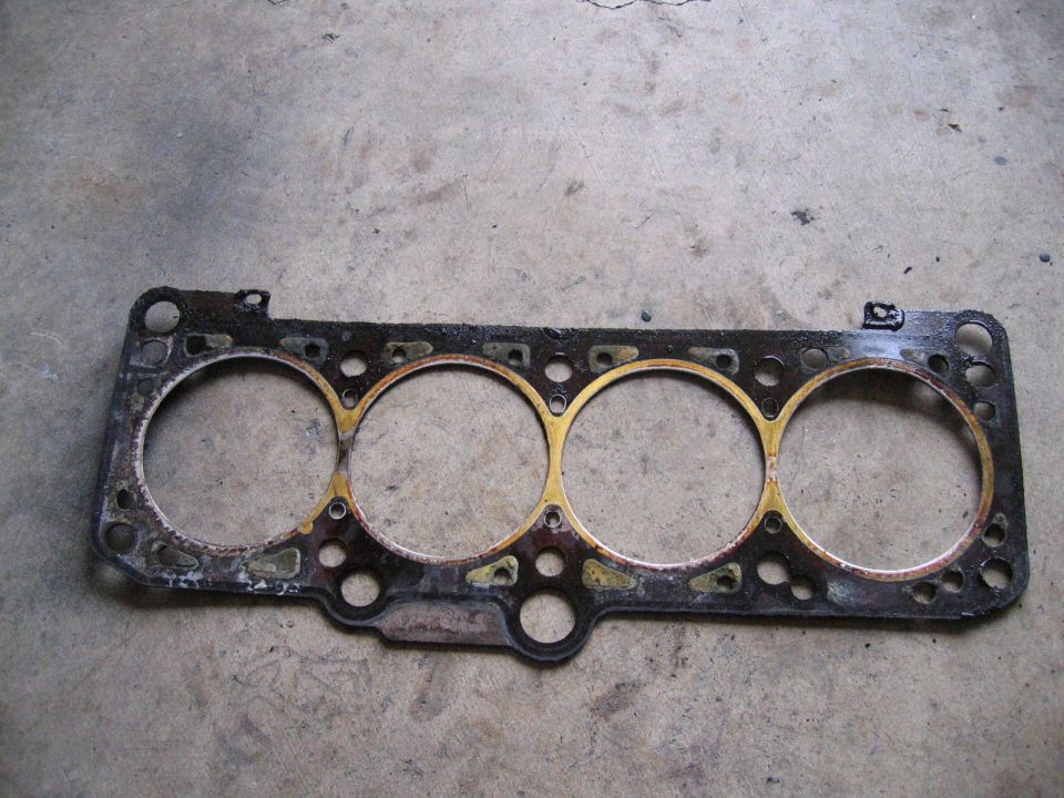 used engine head gasket with four cylinder openings
