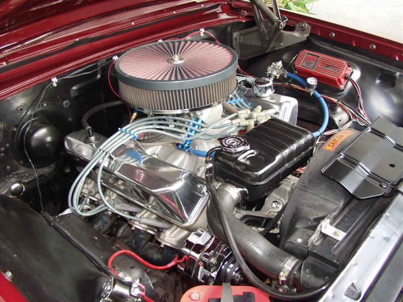 V8 engine bay with chrome air cleaner, finned valve covers, blue plug wires and red MSD ignition box