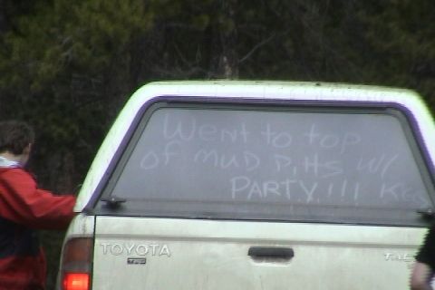 1979 Ford Bronco - Toyota pickup truck with writing on the rear window about going to mud pits.