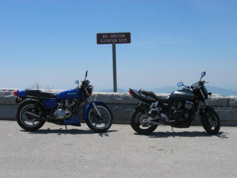 1985 Ford LTD Crown Victoria - Two motorcycles are parked at Big Junction, an overlook with a sign indicating an elevation of 5235 feet.