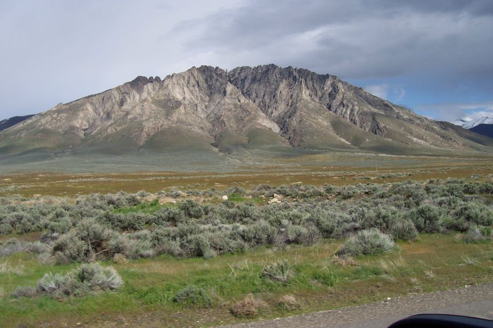 Mountain landscape with sagebrush in foreground and cloudy sky