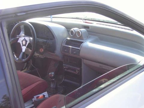 1989 Ford Probe - The interior of a car is shown, the dashboard, steering wheel, and seats.
