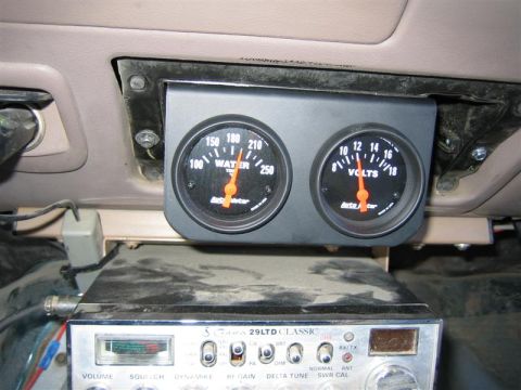 1994 Ford Bronco - Close-up of aftermarket gauges and a CB radio installed in a vehicle's interior.