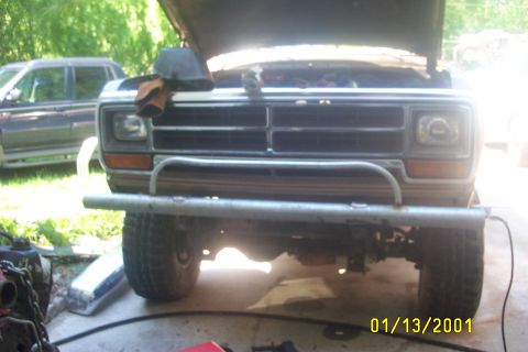 1979 Ford F-150 - Frontal view of a Dodge Ram pickup truck, hood up, with a custom bumper. A second vehicle is parked nearby.