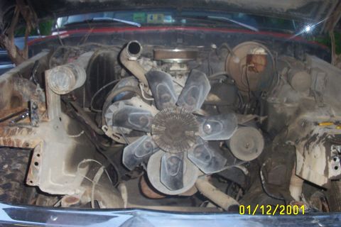 1979 Ford F-150 - The engine bay of a vehicle is shown, with various mechanical parts and the fan prominently displayed.