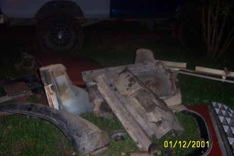 1979 Ford F-150 - Various vehicle parts are strewn across the grass, with a visible date stamp of January 12, 2001.