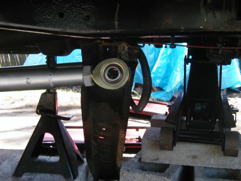 1994 Ford Bronco - Vehicle suspension linkage and heim joint assembly on jack stands, undergoing maintenance or modification.