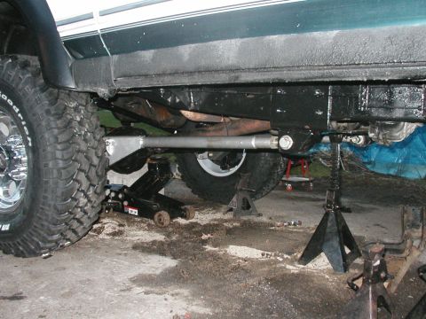 1994 Ford Bronco - The underside of a 1994 Ford Bronco is shown with its rear axle supported by jack stands.
