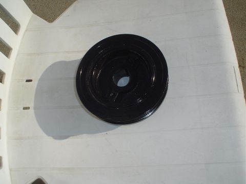 1993 Ford Taurus - Harmonic balancer pulley shown on a white plastic chair.