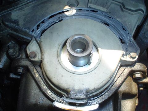 1993 Ford Taurus - This is a close-up view of the engine's crankshaft seal area, showing a metal shaft and surrounding components.