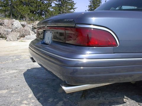 1985 Mercury Grand Marquis - Rear view of a gray Mercury Grand Marquis with chrome trim and dual exhaust pipes.