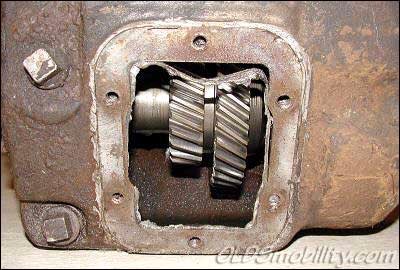1971 Ford Bronco - Close-up view of internal transmission gears within a corroded housing, showing wear and tear.