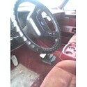 1995 Ford Bronco - Very small, low-resolution interior thumbnail showing a steering wheel with a dark laced-on cover, the dashboard and column, and red uphols…