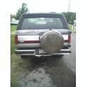 1995 Ford Bronco - Rear view of a 1995 Ford Bronco, showing the spare tire and trailer hitch.