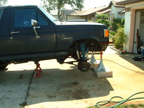 1995 Ford Bronco - This 1995 Ford Bronco is shown on jack stands with its front wheel removed, indicating maintenance or modification work.