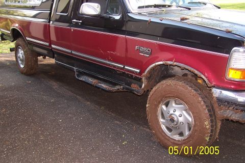 1979 Ford Bronco - Muddy Ford F-250 pickup truck parked on asphalt. Date stamp shows 05/01/2005.