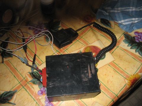 1986 Ford Bronco - Radio equipment, including a transceiver and microphone, is spread out on a patterned tablecloth.