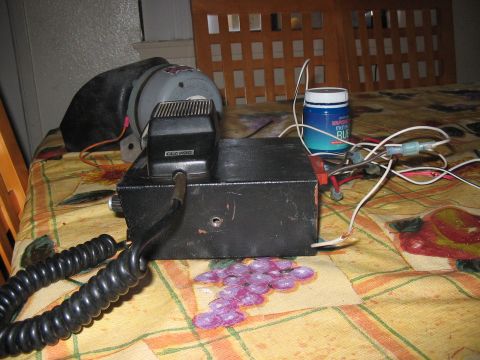 1986 Ford Bronco - A CB radio and speaker setup, possibly for a vehicle, sits on a patterned tablecloth.