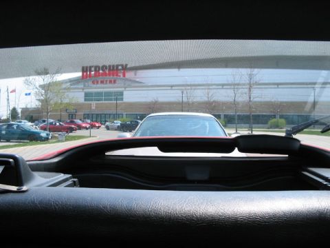 1993 Ford Probe - A view from inside a car shows a parking lot with multiple vehicles and the Hershey Centre in the background.