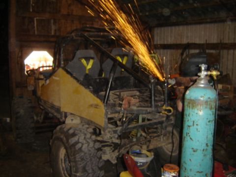 1989 Ford Bronco - Grinding sparks fly as this off-road vehicle undergoes modification in a workshop.
