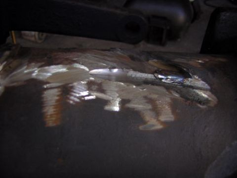 1995 Ford Bronco - This image shows a close-up of a metal component with evidence of welding and some threaded sections.