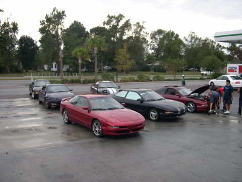 1997 Ford Probe - Several Ford Probes are parked in a lot, with one having its hood open.