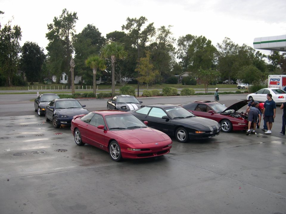Red 1993 Ford Probe in foreground, with four other Probes behind it