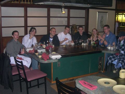 1997 Ford Probe - A group of friends gathers around a table in a restaurant, enjoying a meal together.