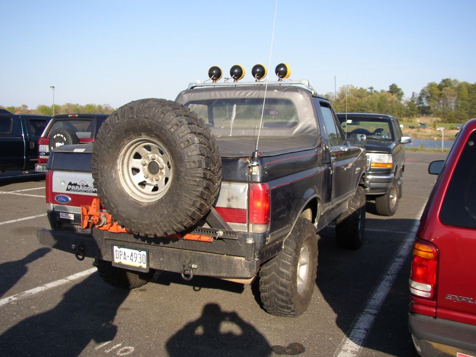 1995 Ford Bronco rear view with spare tire and four lights on roof rack