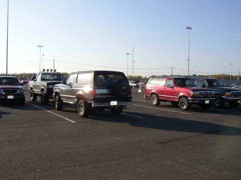 1995 Ford Bronco - A dark gray 1995 Ford Bronco is parked in a lot alongside other vehicles.