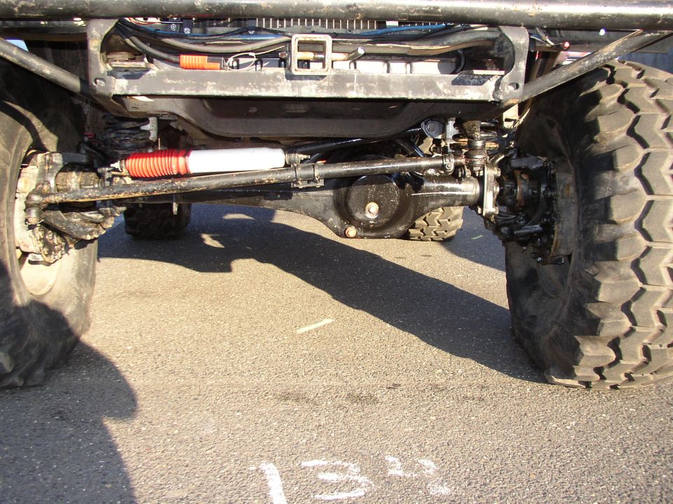 Front axle and suspension with large tires and red shock absorber